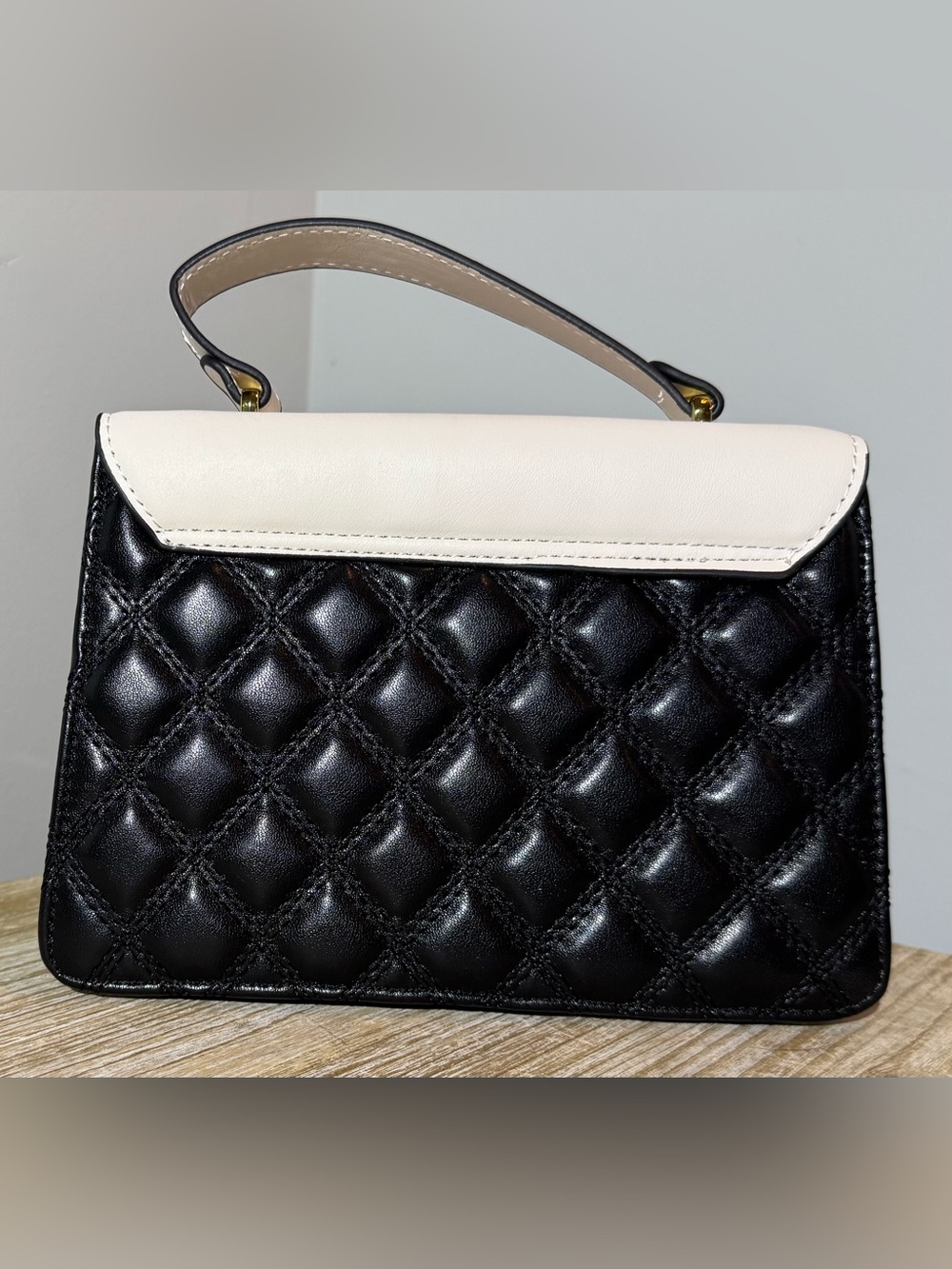 White and Black Quilted Top-Handle Bag with Gold Emblem - Picture 2 of 11
